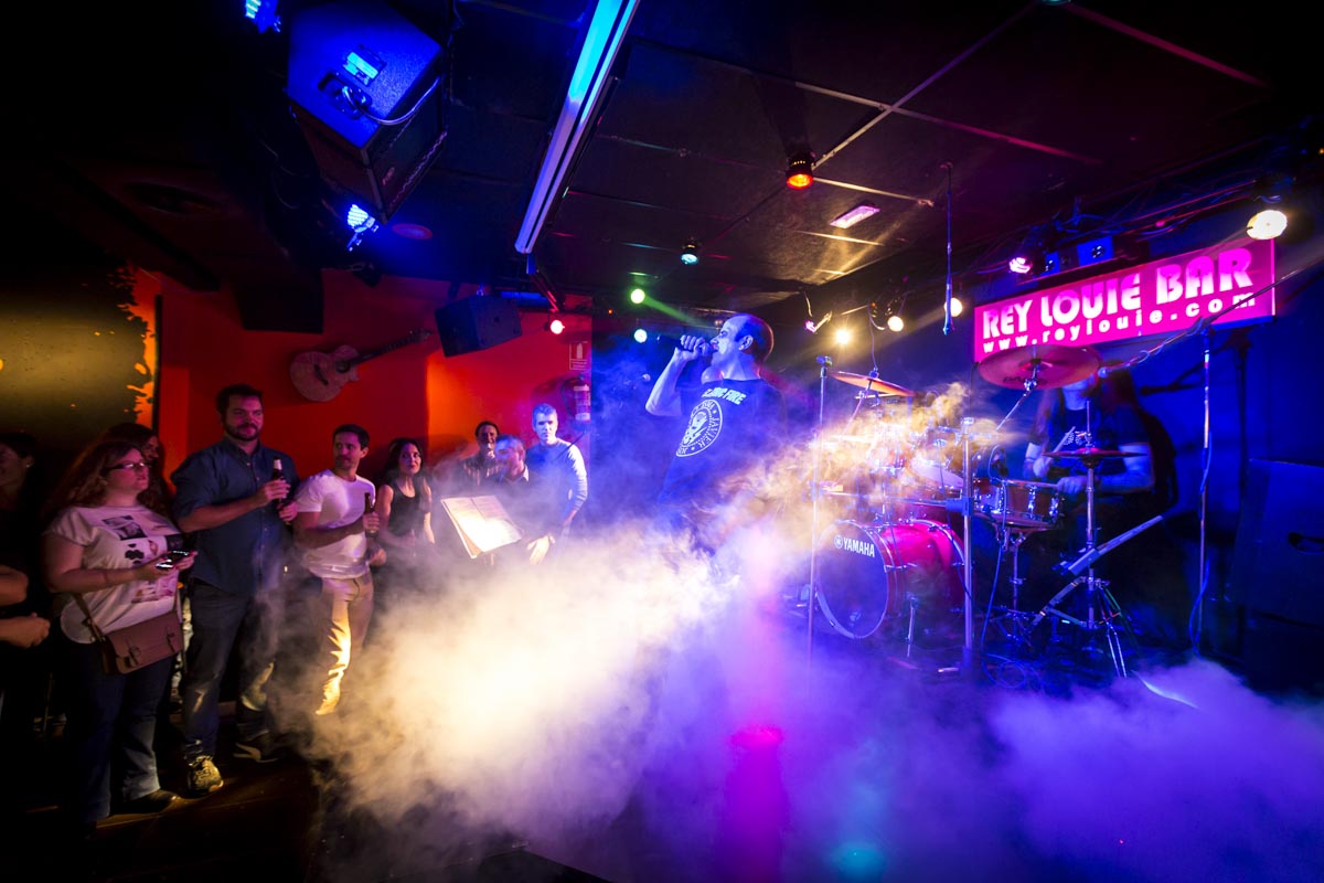 Escenario con humo y público en Rey Louie Bar